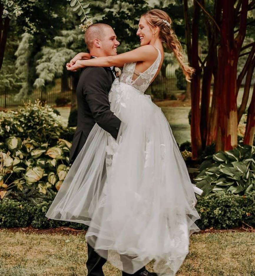 Сouple wearing a white gown and a black suit