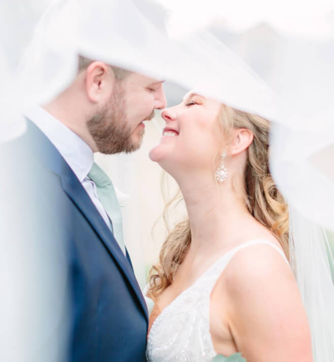 Сouple wearing a white gown and a black suit