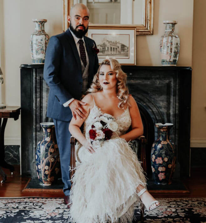 Сouple wearing a white gown and a black suit