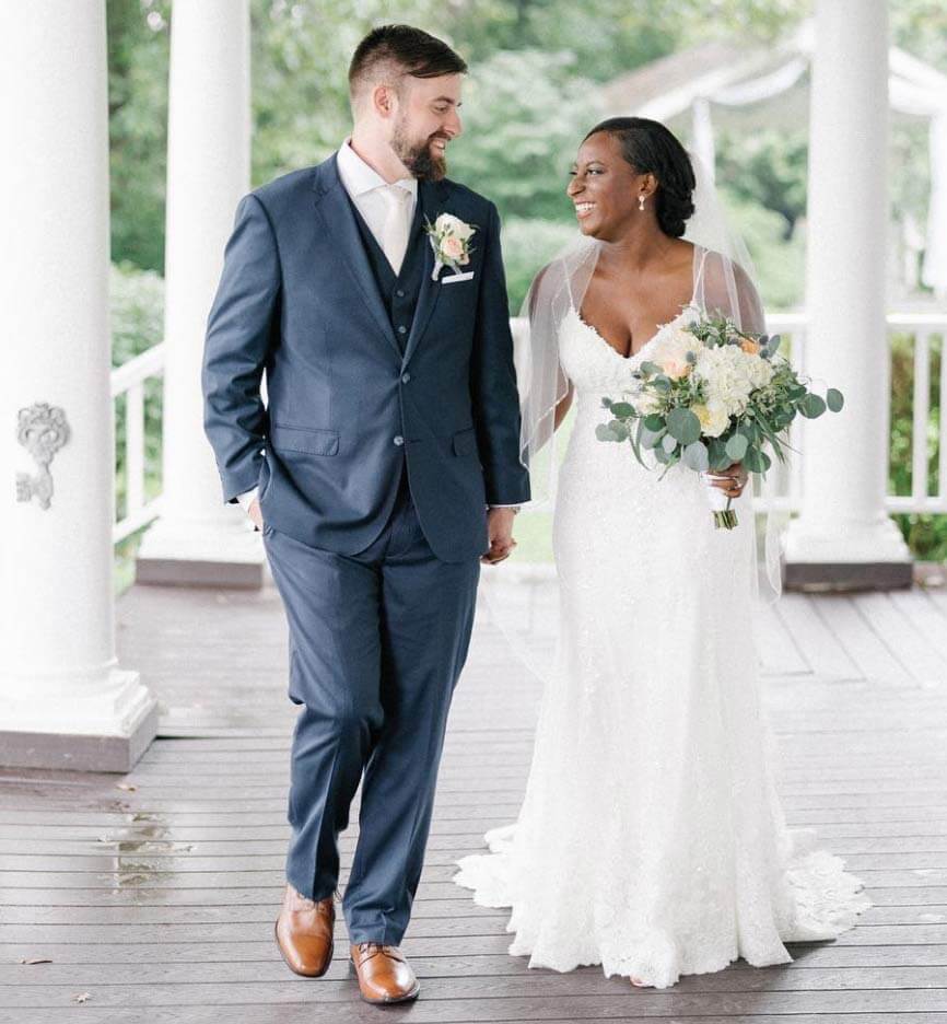 Сouple wearing a white gown and a black suit