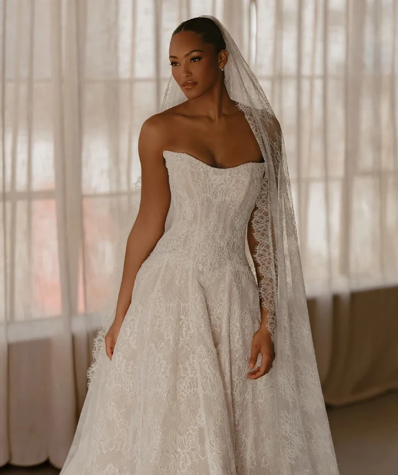 Model wearing a white gown by Martina Liana